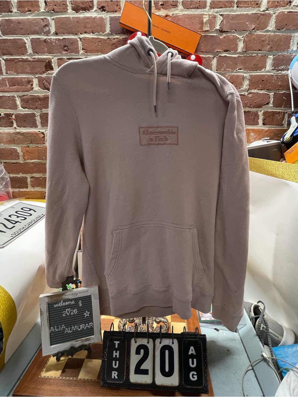 light pink Abercrombie & Fitch pullover hoodie featuring a faded box logo